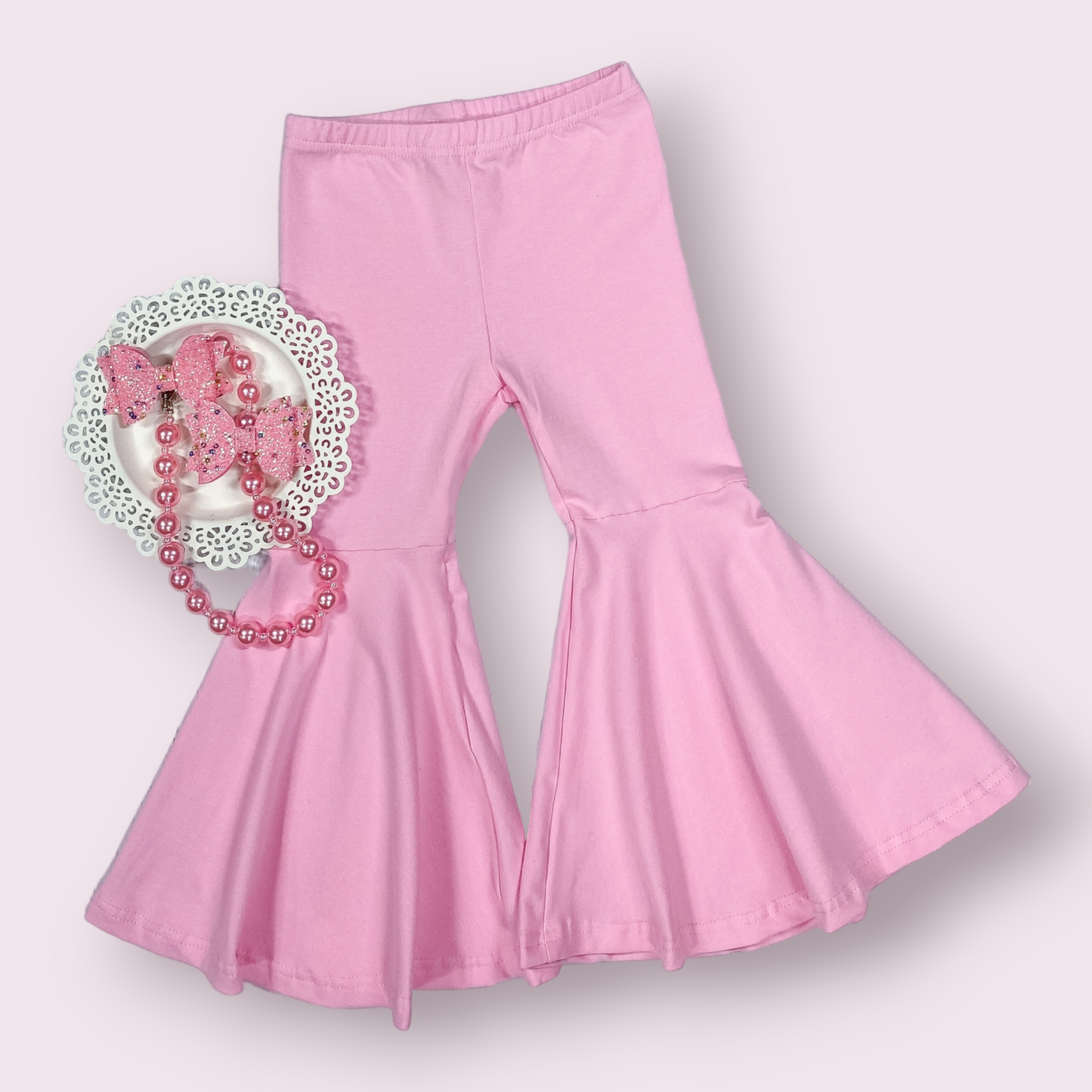 Pink bell bottom pants in soft cotton blend fabric.