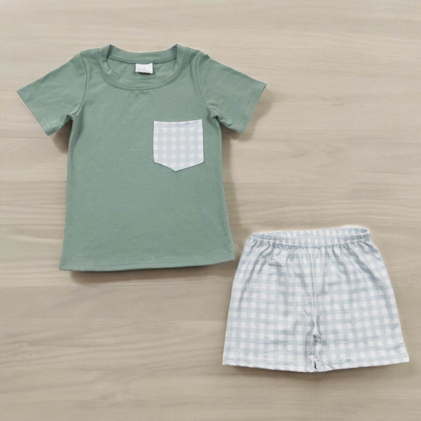 Green plaid shorts set with green T-shirt featuring plaid pocket, 95% cotton and 5% spandex.