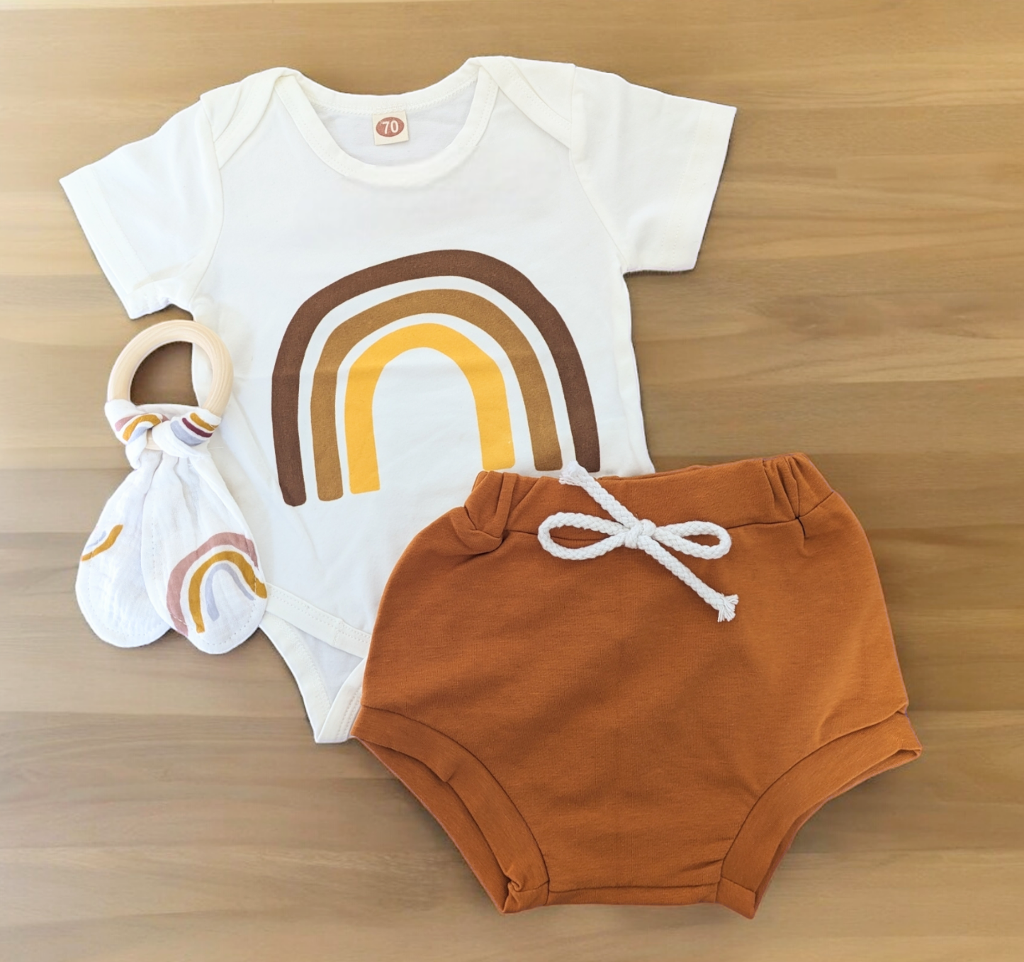 Rainbow Outfit with rainbow-print bodysuit and rust shorts, includes optional rabbit ear teether.