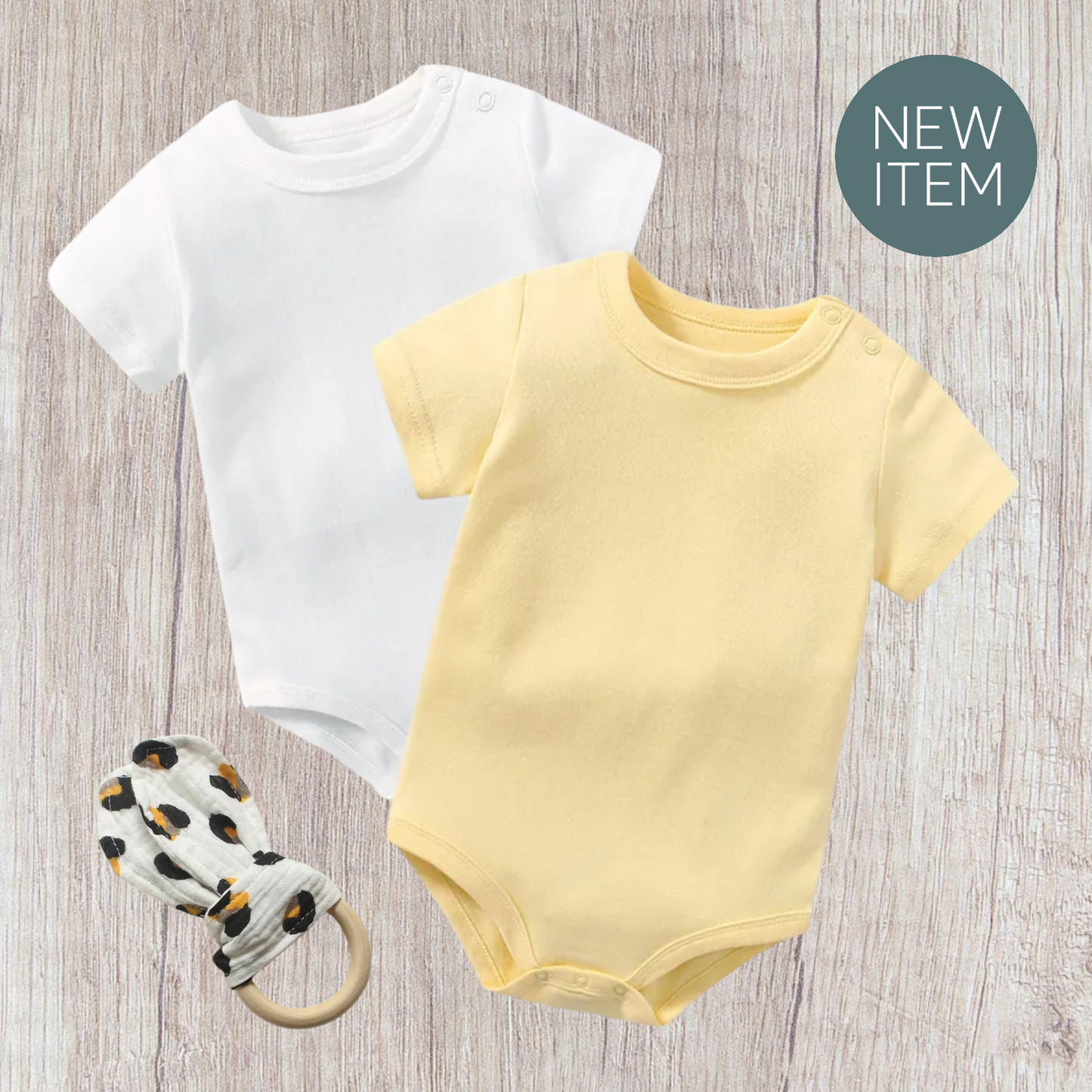 Baby bodysuit set with teether; includes white and yellow bodysuits plus a rabbit ear teether; soft cotton fabric.