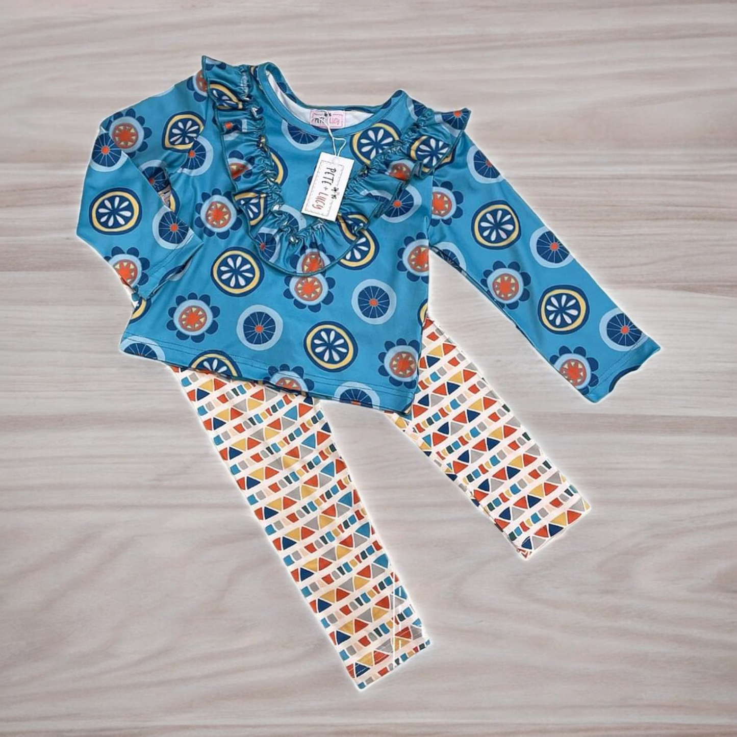 Retro Geo 2 Piece Pant Set with jewel neckline, ruffle hem, long sleeves, and geometric pattern.