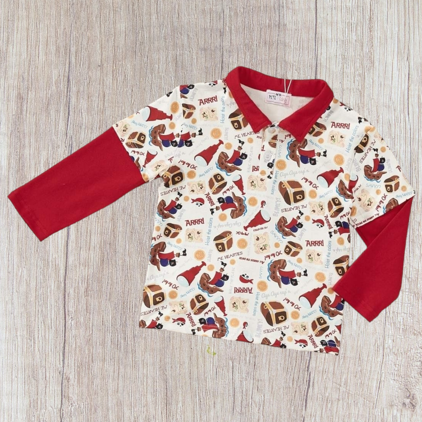 Collared long-sleeve Buried Treasure Boy Top with playful pirate theme.