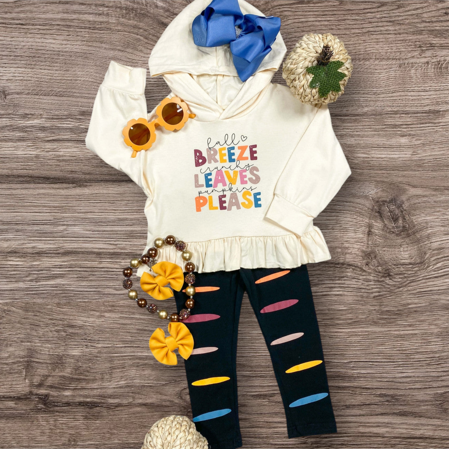 Fall Breeze Sweatshirt and Colorful Pants Set on display with autumn-themed accents.