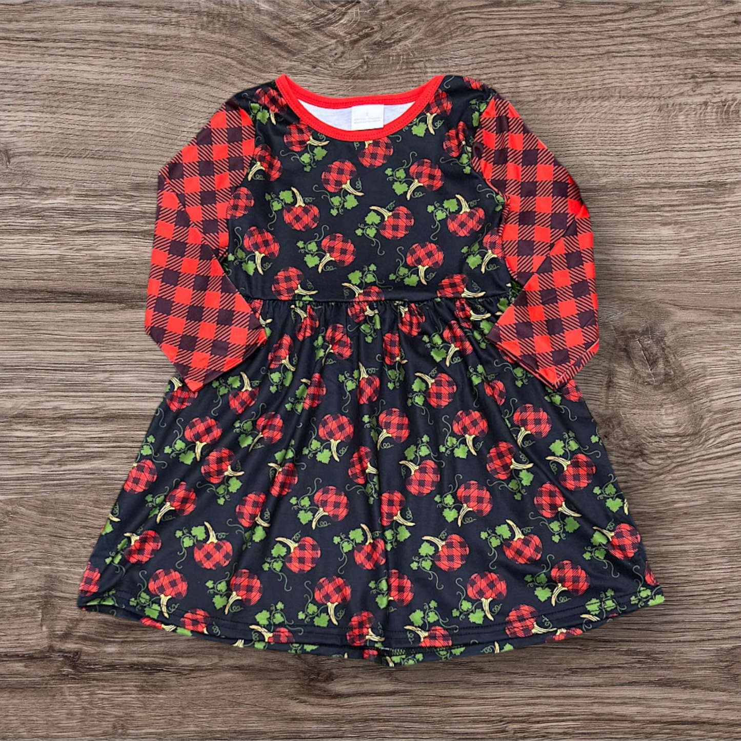 Kids plaid pumpkin dress with black base and red plaid sleeves for fall winter