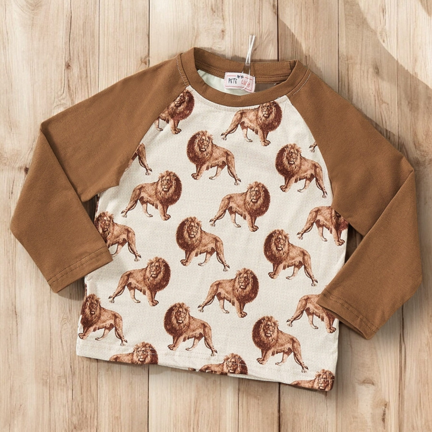 Safari boy top with lion print, brown raglan sleeves, long sleeve crew neck.