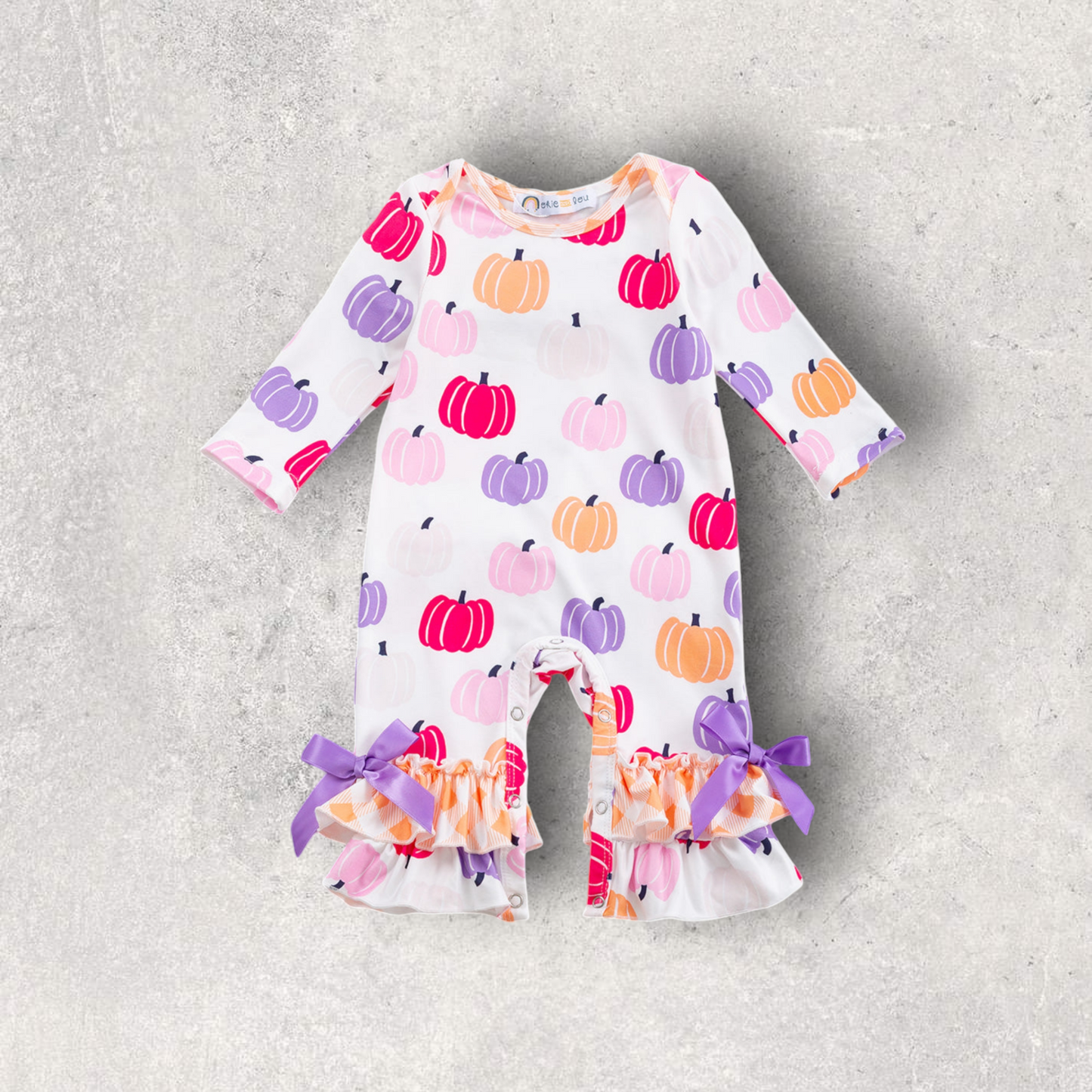 Pumpkin Party Romper with pastel pumpkin print and purple bow ruffled leg cuffs for babies