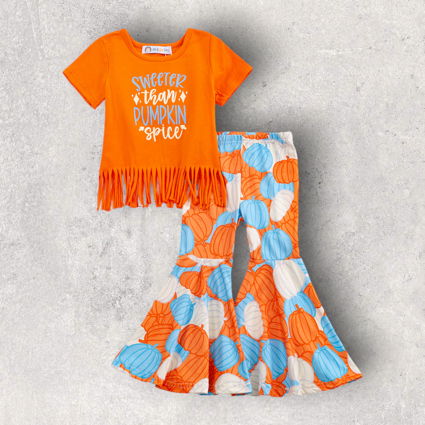 Orange fringe top with "Sweeter than Pumpkin Spice" text and bell-bottom pumpkin print pants fall outfit set