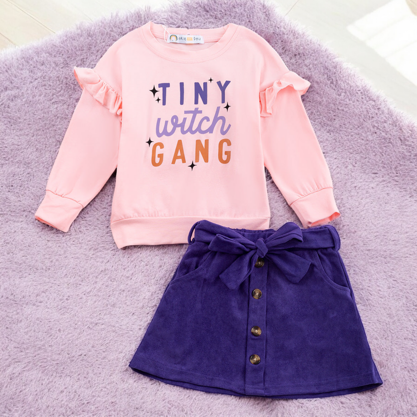 Tiny Witch Gang skirt set with light pink ruffled top and purple bow skirt for Halloween kids