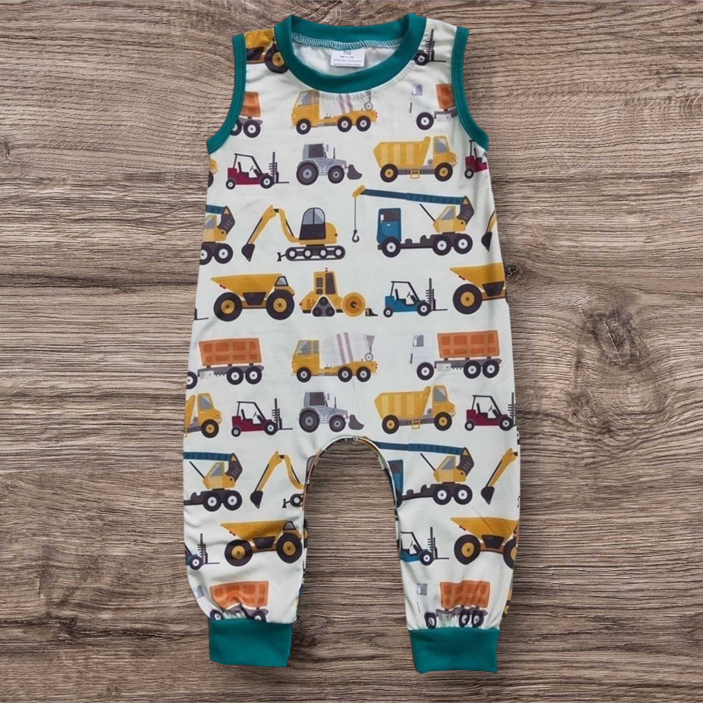 Trucks sleeveless romper with construction vehicle print, 95% cotton, 5% spandex.