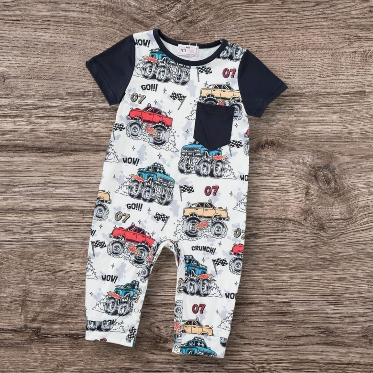 Mud Mayhem Boy Romper with monster truck print, short sleeves, and chest pocket.