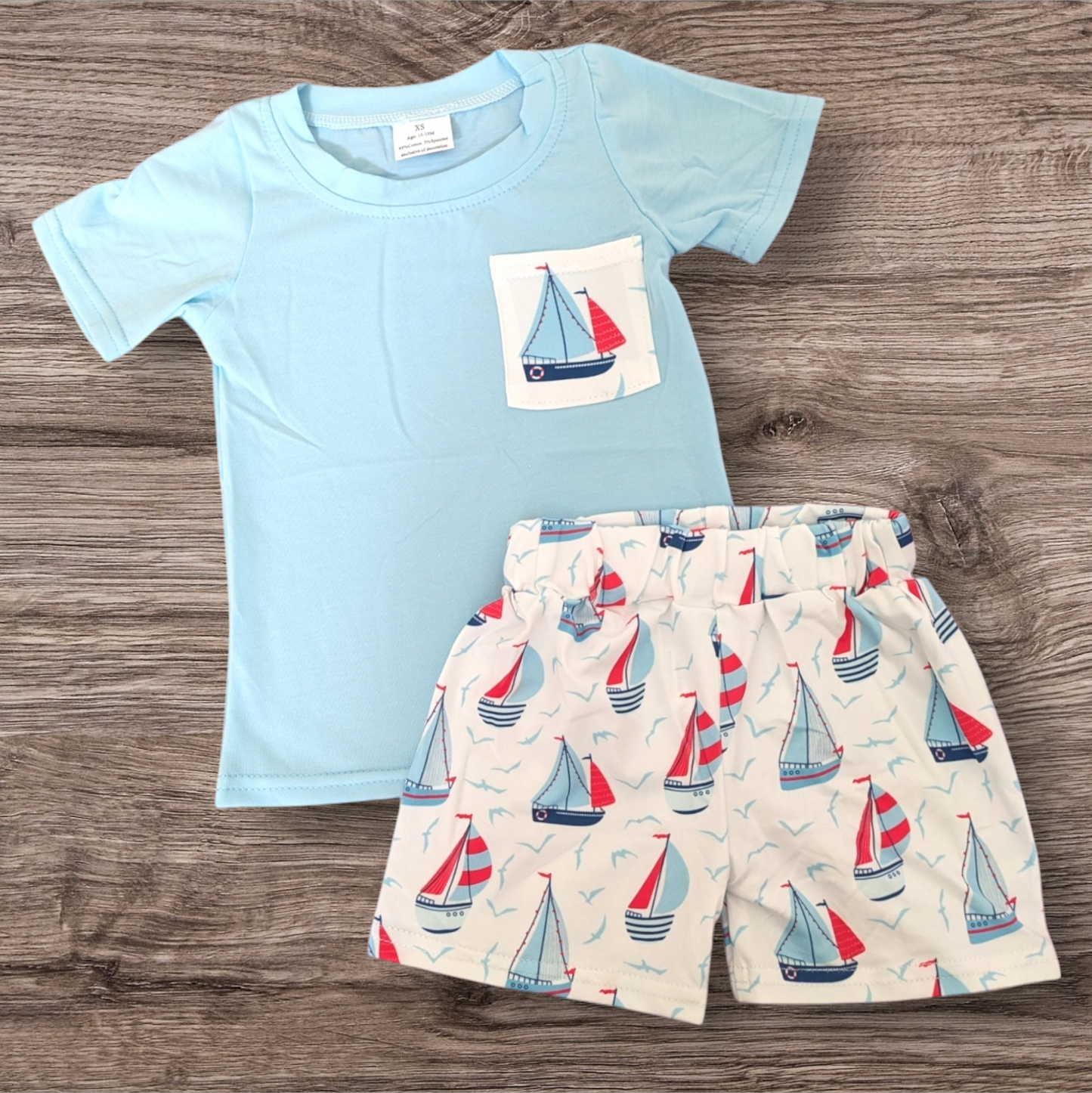 Light blue Sail Away Shorts Set with sailboat print; 95% cotton, 5% spandex; true to size fit.