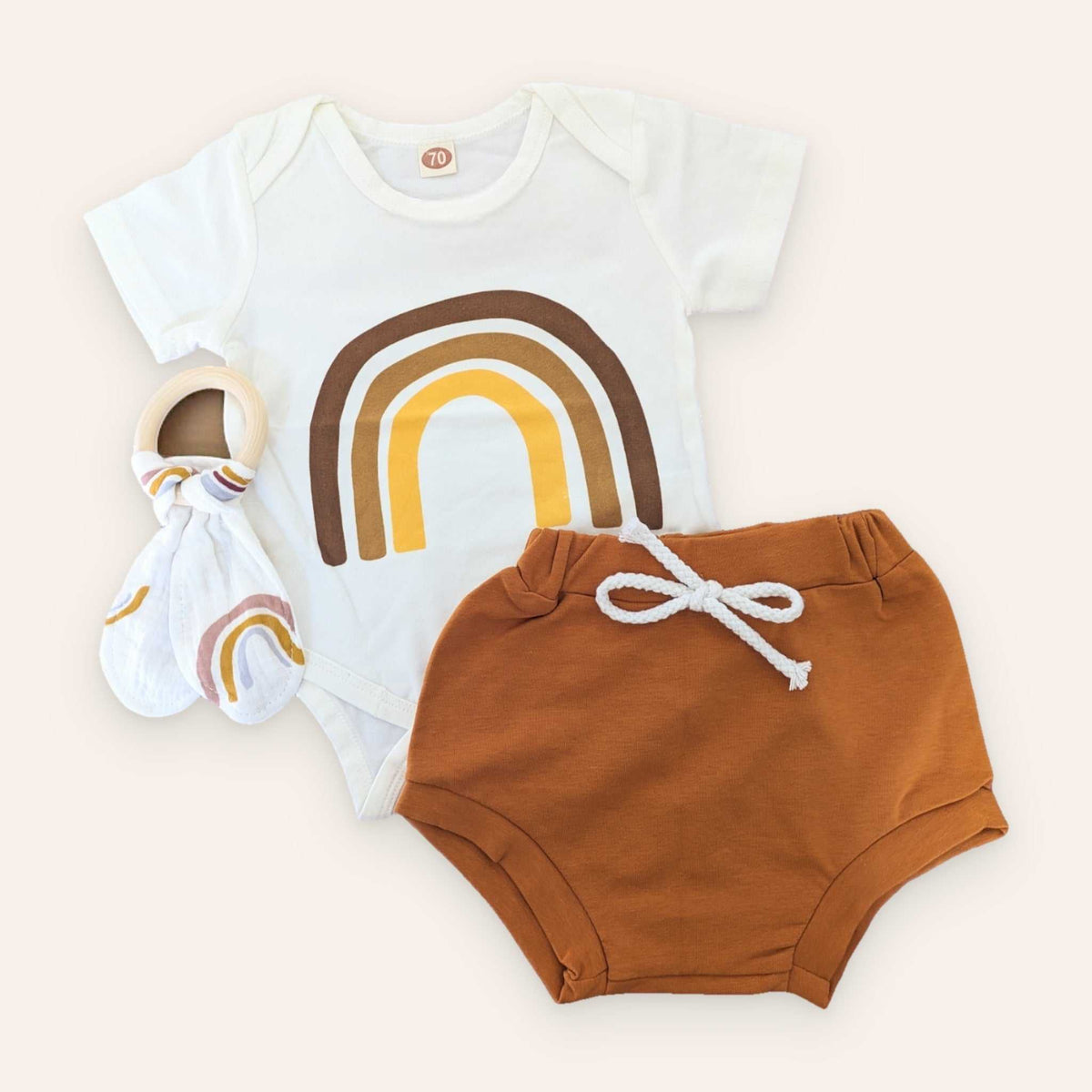 Rainbow Outfit with rainbow-print bodysuit and rust shorts, includes optional rabbit ear teether.
