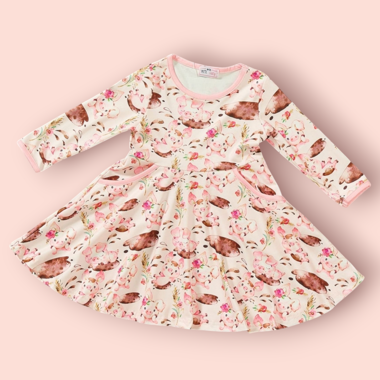 Charlotte Dress with playful piglet and floral print, long sleeves, jewel neckline, and pockets, perfect for kids.