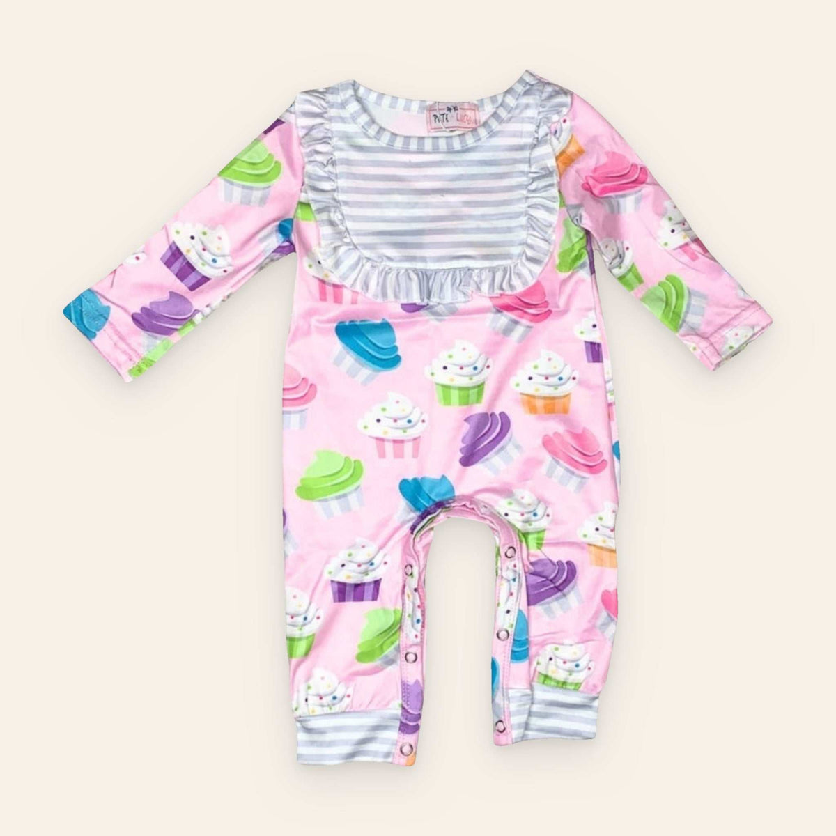 Sweet Dreams Cupcake Romper with colorful cupcake pattern and long sleeves.