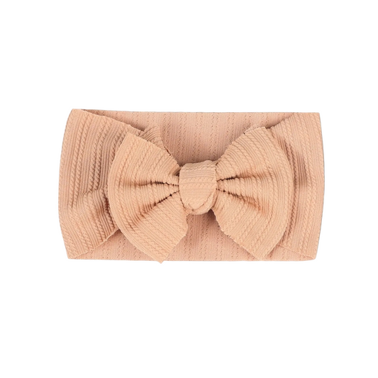 Baby bow headband in nude color, soft and stretchy accessory for babies
