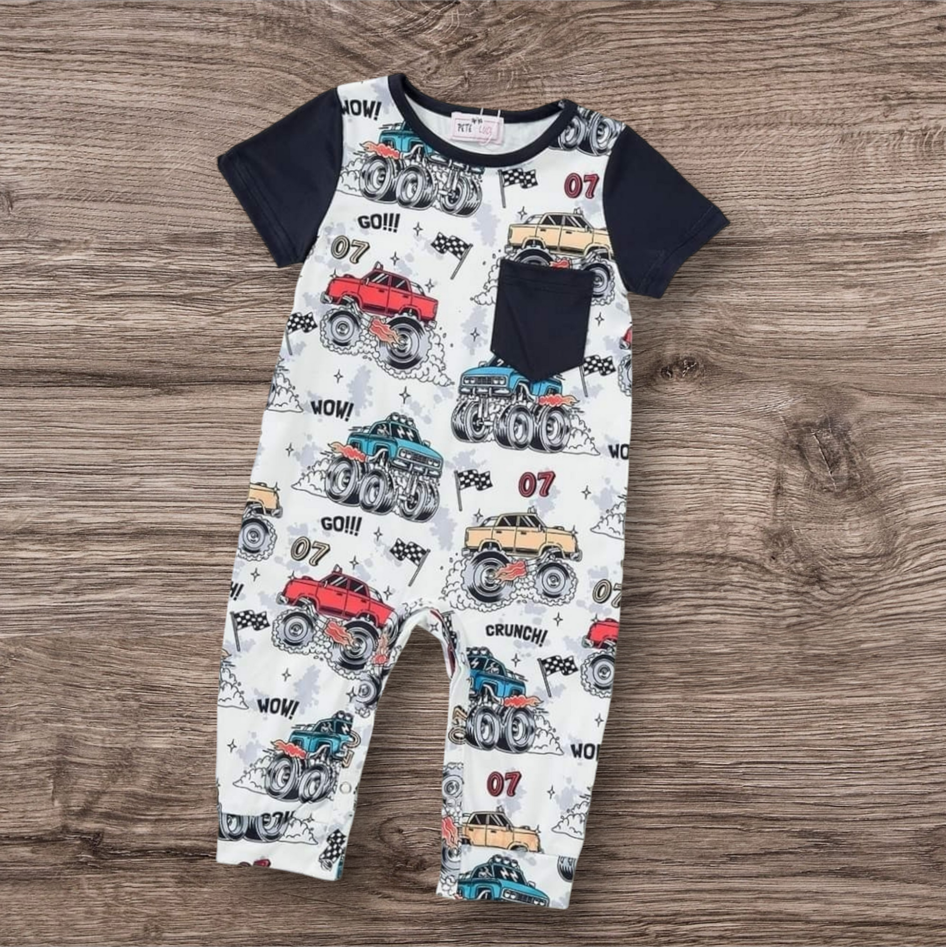 Mud Mayhem Boy Romper with monster truck print, short sleeves, and chest pocket.