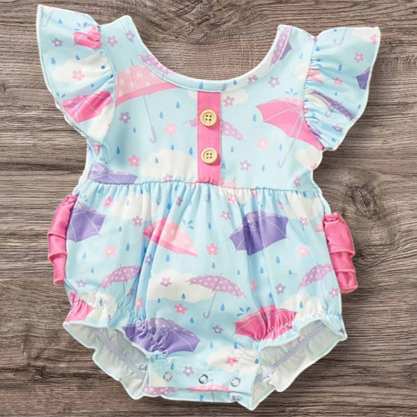 Cute Rainy Days Romper with umbrella print and ruffled sleeves.