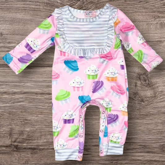 Sweet Dreams Cupcake Romper with colorful cupcake pattern and long sleeves.