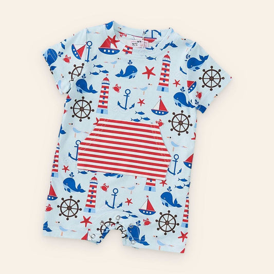 Nautical-themed boy romper with whales, anchors, and lighthouses, made from P-Lush fabric.