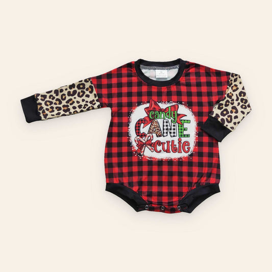 Baby romper, Candy Cane Cutie, in red and black buffalo plaid with leopard-print sleeves, black trim and festive graphic.