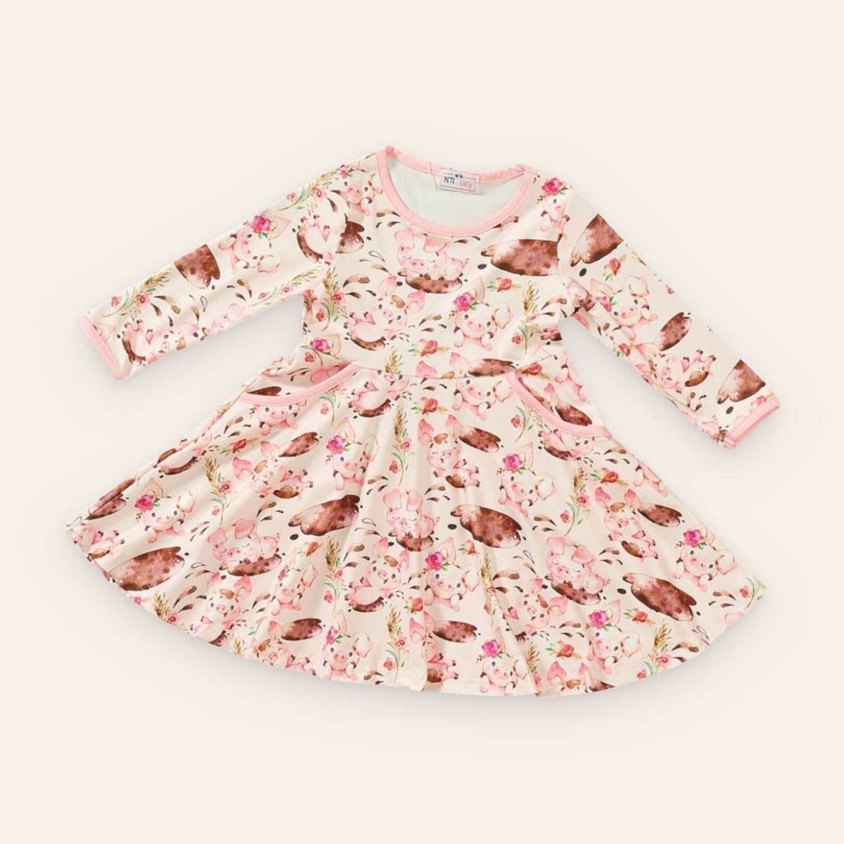 Charlotte Dress with playful piglet and floral print, long sleeves, jewel neckline, and pockets, perfect for kids.