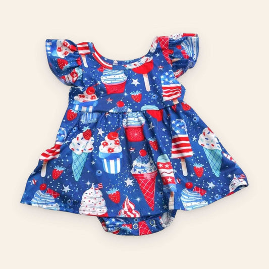 Cupcake Patriotic Romper in blue cotton-blend fabric, with a red, white, and blue cupcake print, flutter sleeves, and skirted bottom.