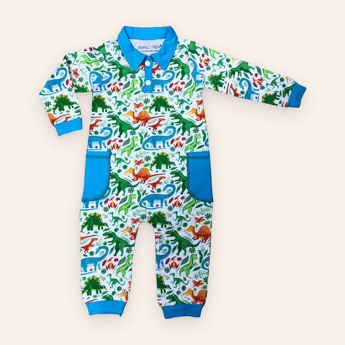 Dinosaur print boy's long sleeve romper with blue collar and cuffs.