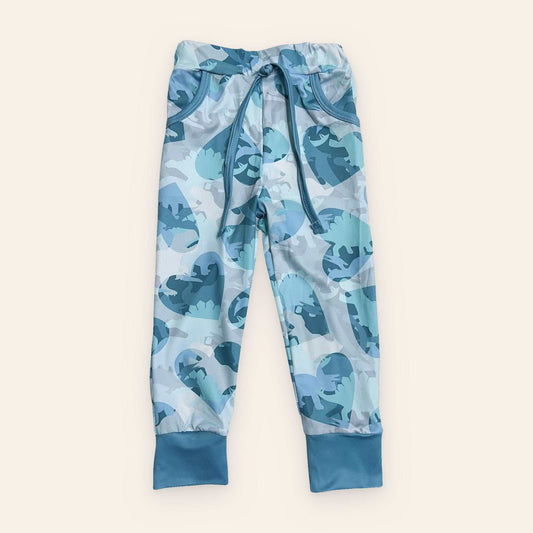 Blue and gray dinosaur print joggers for kids made of cotton and spandex with adjustable drawstring waistband and cuffed ankles