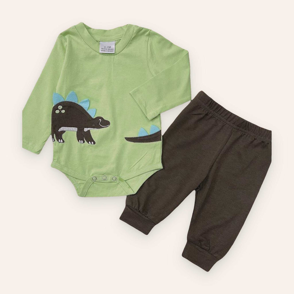 Green baby dinosaur two piece pant set with long sleeve bodysuit and brown pants, made of cotton and spandex.