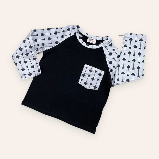 Black and gray raglan sleeve Wild Boy Shirt with heart and arrow pattern.