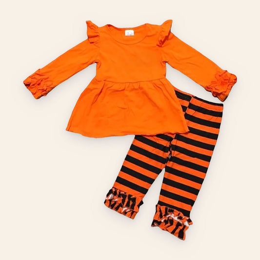 Bright orange pumpkin patch perfection outfit with long ruffled sleeves and black striped leggings.
