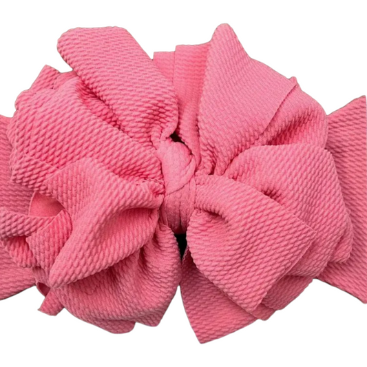 Jumbo pink textured bow hair accessory for kids adding charm and elegance