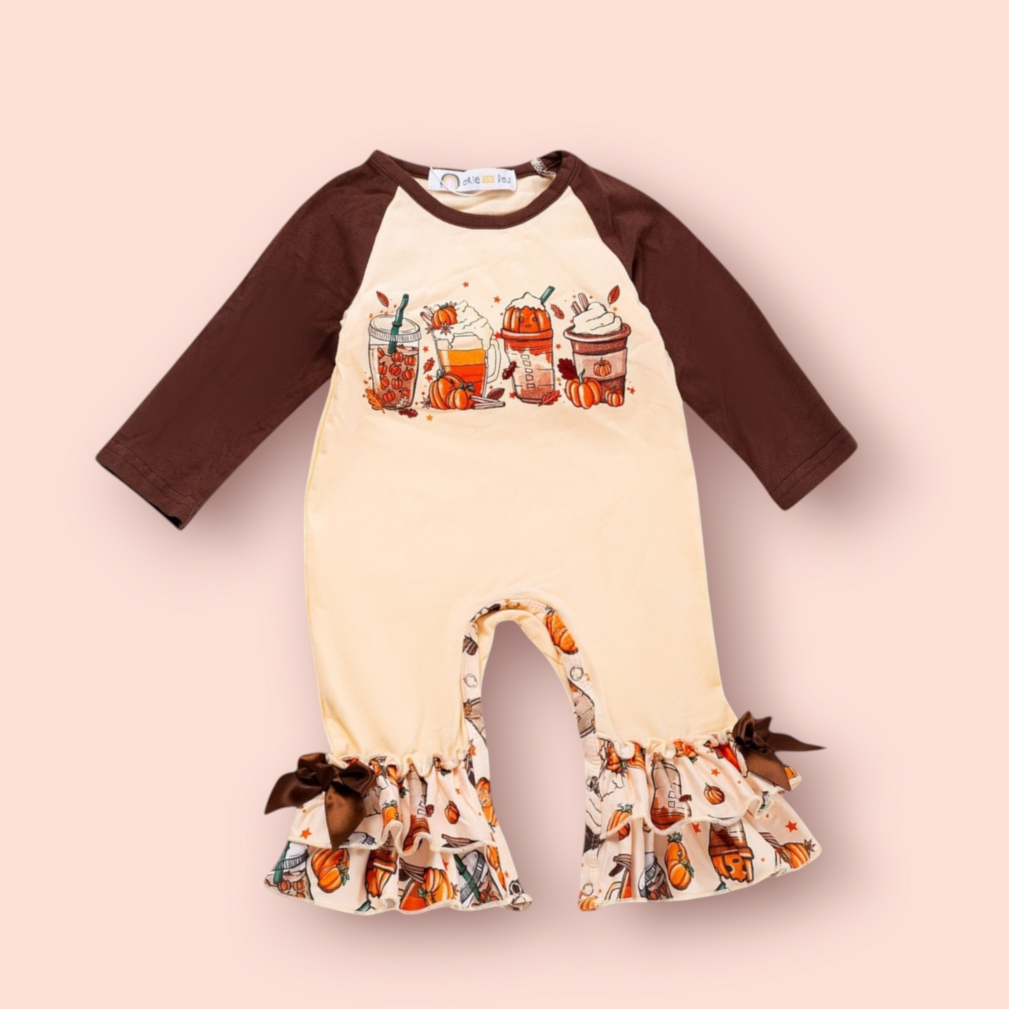 Cozy Cup Fall Romper with autumn drinks graphic, cream body, brown sleeves, ruffle leg details with pumpkins and bows.
