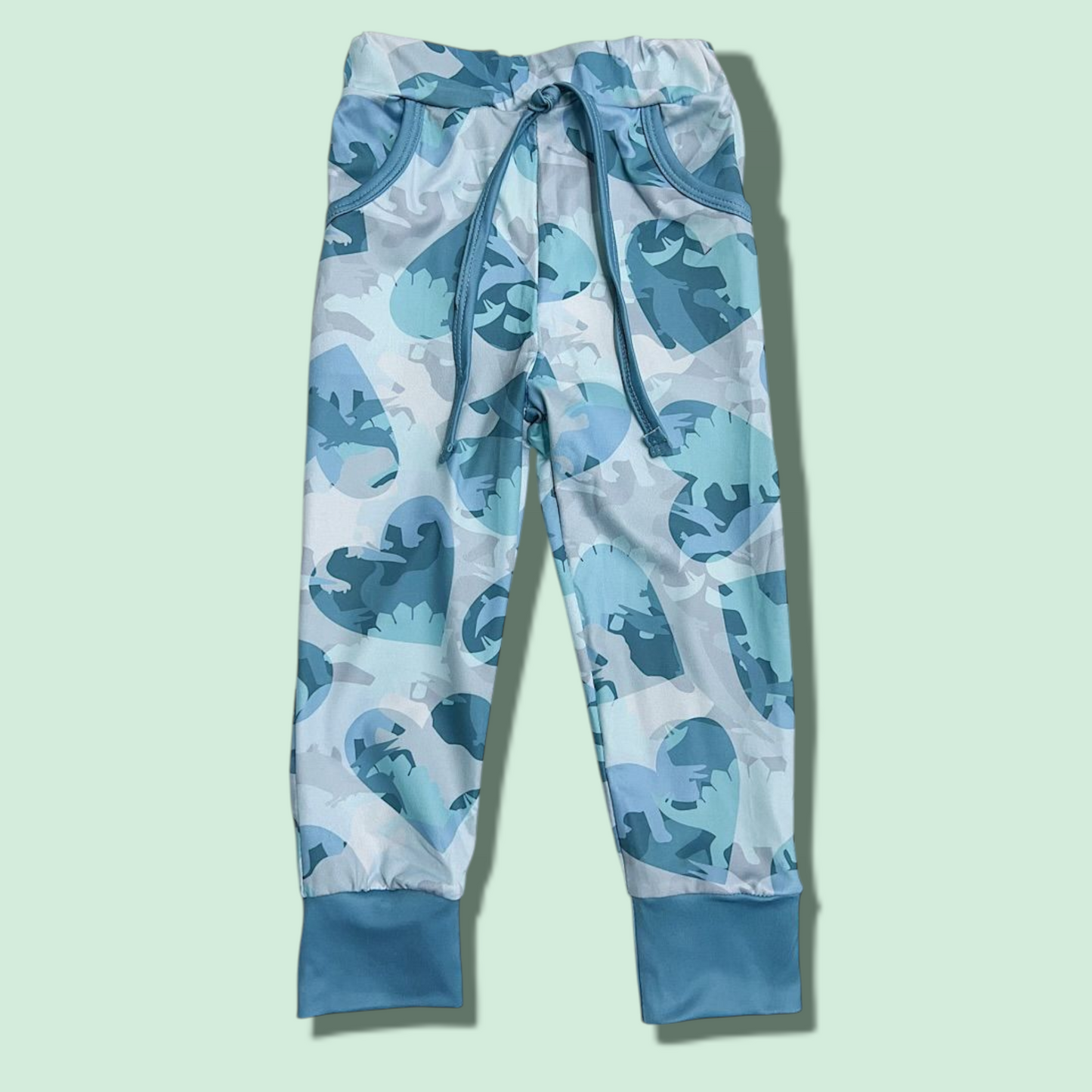 Blue and gray dinosaur print joggers for kids made of cotton and spandex with adjustable drawstring waistband and cuffed ankles