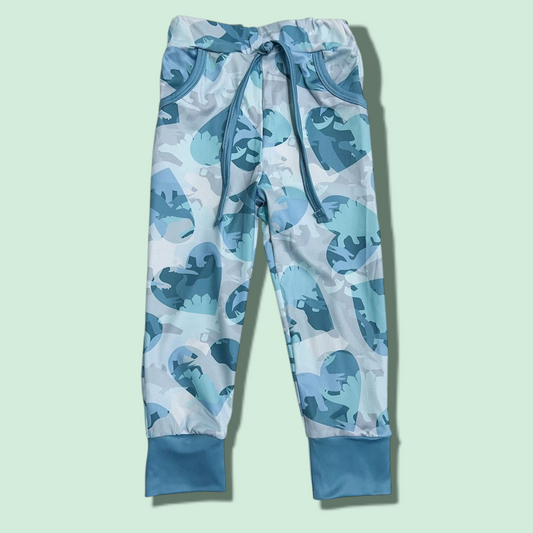 Blue and gray dinosaur print joggers for kids made of cotton and spandex with adjustable drawstring waistband and cuffed ankles