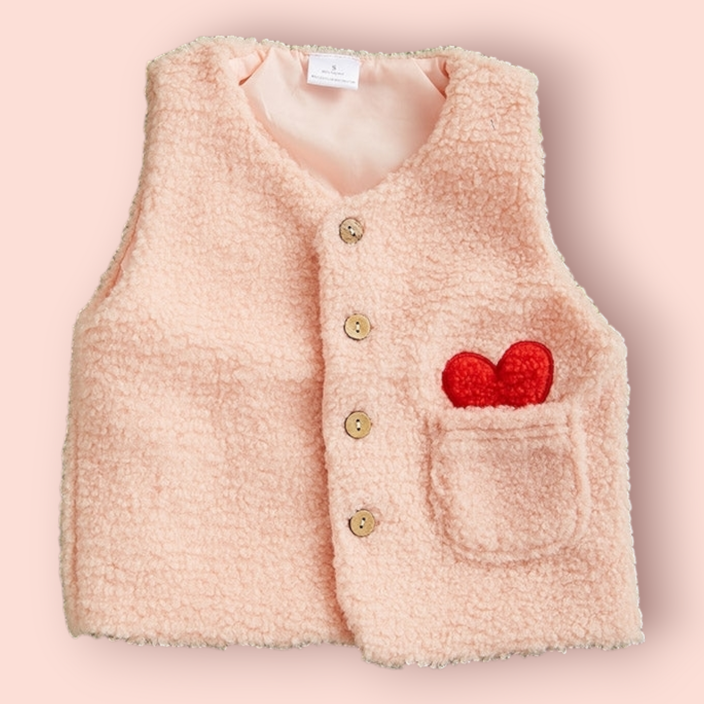 Pink Sherpa Vest for toddlers with button closure and heart detail on pocket