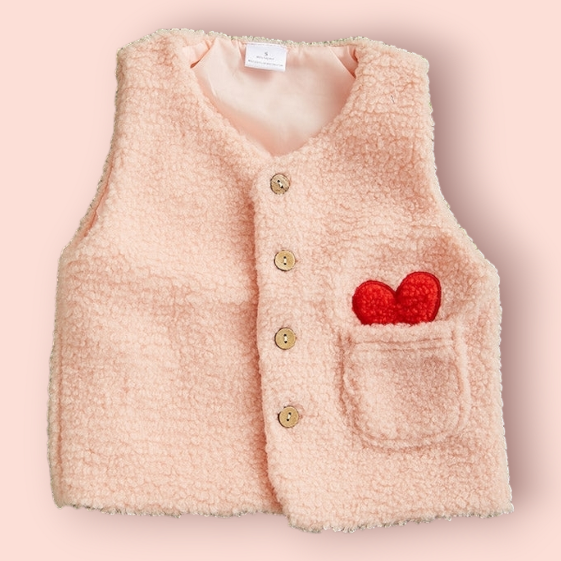 Pink Sherpa Vest for toddlers with button closure and heart detail on pocket