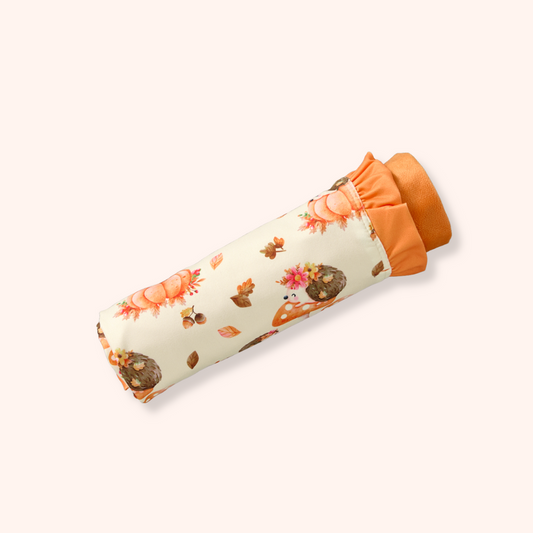 Rolled Hedgehog Hollow Minky Blanket with orange and hedgehog pattern on cream background