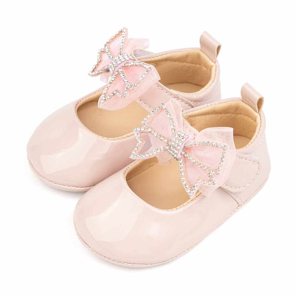 Pink baby shoes with rhinestone bow decoration, soft sole, and comfortable fit.