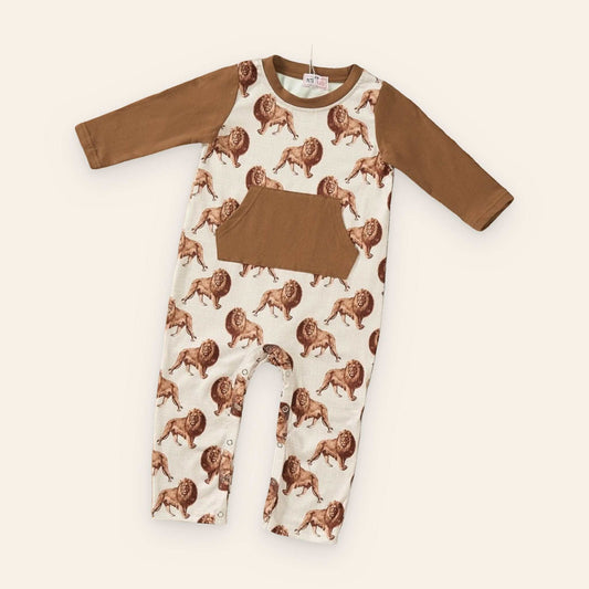 Safari Boy Romper in cream with brown lion print, solid brown sleeves and kangaroo pocket, and snap-leg closures.