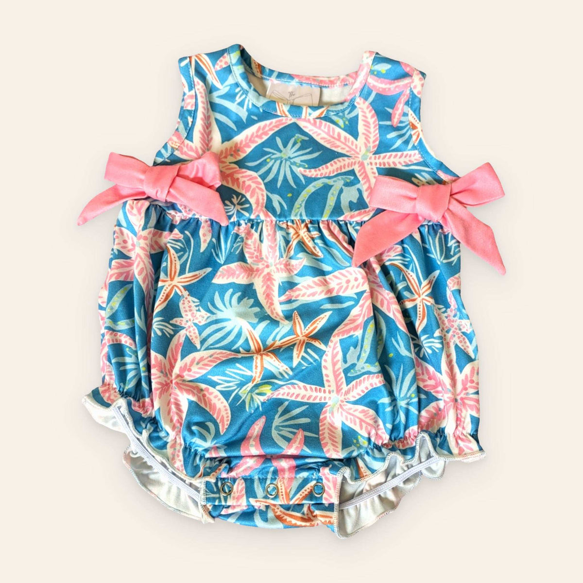 Starfish Galore Infant Romper with pink bows, starfish pattern, and sleeveless design.