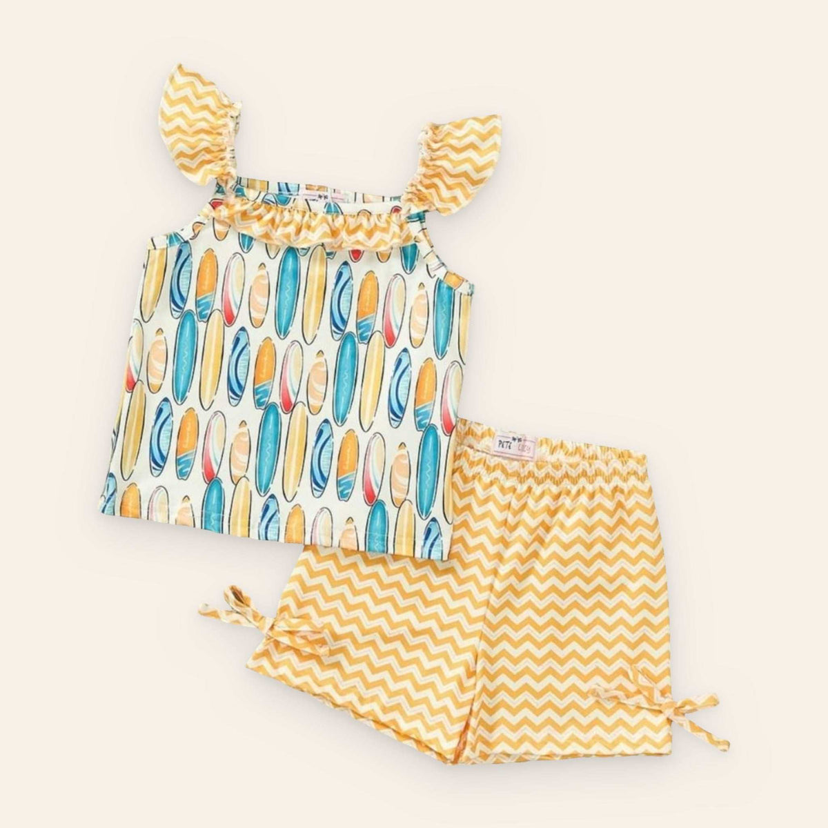 Colorful surfboard-themed 2 piece set with chevron shorts, made from P-Lush fabric.