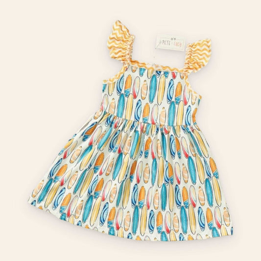 Cute dress with surfboard pattern and ruffled straps.