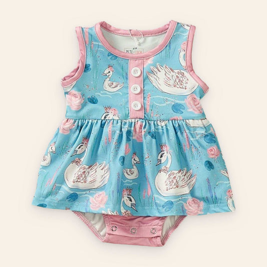 Swan Song Romper with swan and floral print, blue and pink, sleeveless design.